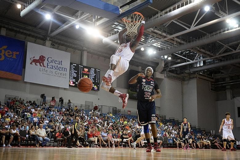 The Singapore Slingers centre Justin Howard (white jersey) dunks home two of his game-high 24 points in his team's convincing 80-58 Asean Basketball League win over the Pilipinas MX3 Kings at the OCBC Arena yesterday afternoon. The table-topping Slin