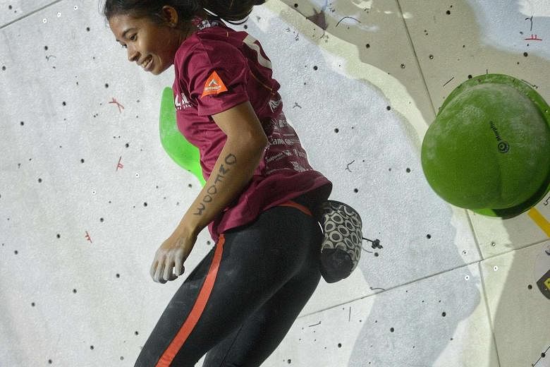 Indonesian national climber Fitria Fartani, 20, successfully reached the end tile in yesterday's Women's final (Open category) of Gravical 2016, an annual bouldering competition organised by Singapore Management University. She was the only woman to 