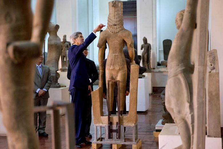  US Secretary of State John Kerry looks at a statue while touring the National Museum of Cambodia in Phnom Penh. 