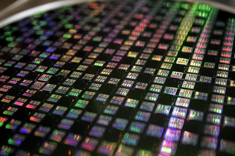 A wafer at TSMC, the world's biggest contract chipmaker. The company, which supplies some of the chips that go into the iPhone, says first-quarter revenues will likely fall by up to 11 per cent year-on-year.