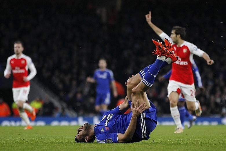Chelsea striker Diego Costa reacts after being fouled by Arsenal defender Per Mertesacker (not in picture). Mertesacker received a red card and Costa scored the game's only goal five minutes later.