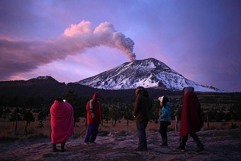 Ash and smoke billow from Mexico's Popocatepetl volcano, one of the world's most dangerous. Thousands of people are on evacuation alert after the volcano, located 56km from Mexico City, started showing warning signs on Sunday of its first eruption si