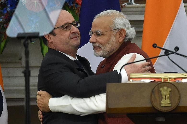 Mr Modi (right) and Mr Hollande after a press conference in New Delhi yesterday. The French President is in India as the chief guest at the country's Republic Day parade.