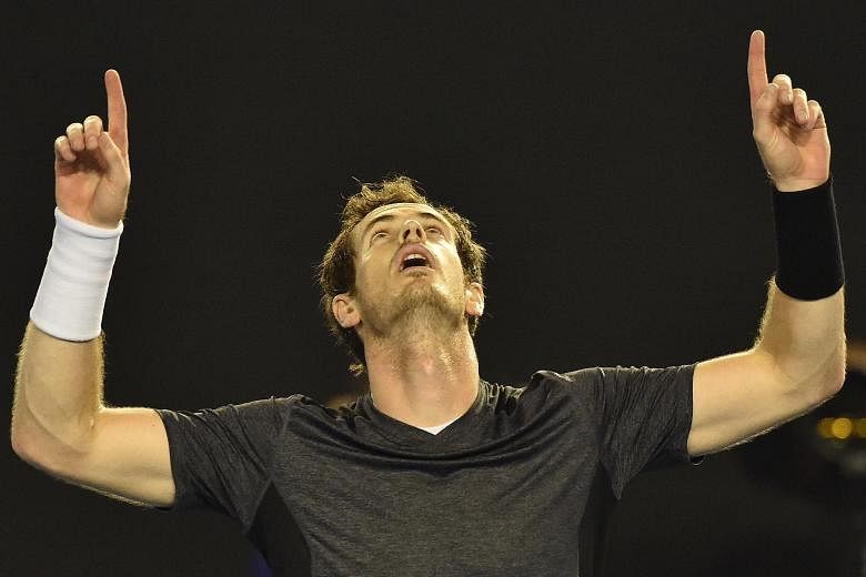 Andy Murray celebrating his 6-4, 6-4, 7-6 (7-4) victory against Australia's Bernard Tomic at Rod Laver Arena yesterday. The Scot said he was "drained" after the collapse of his wife's father on Saturday.