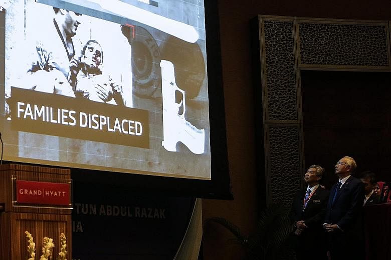 Malaysian Prime Minister Najib Razak (right) and his deputy Ahmad Zahid Hamidi watching a video presentation during the International Conference on Deradicalisation and Countering Violent Extremismin Kuala Lumpur yesterday.