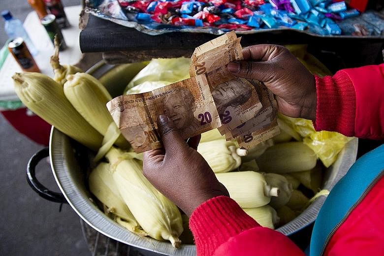 A street trader counting her South African banknotes. Weakening currencies across Africa will make it harder for many of its countries to repay China for loans used to build large infrastructure projects. The economic downturn is also reverberating a