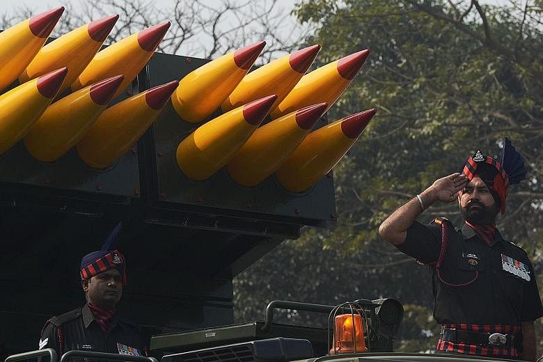 Indian military personnel riding alongside a missile launcher during a parade to mark Republic Day in Kolkata yesterday. In line with the ongoing "Make in India" initiative, the nation has been trying to raise domestic production of its defence equip