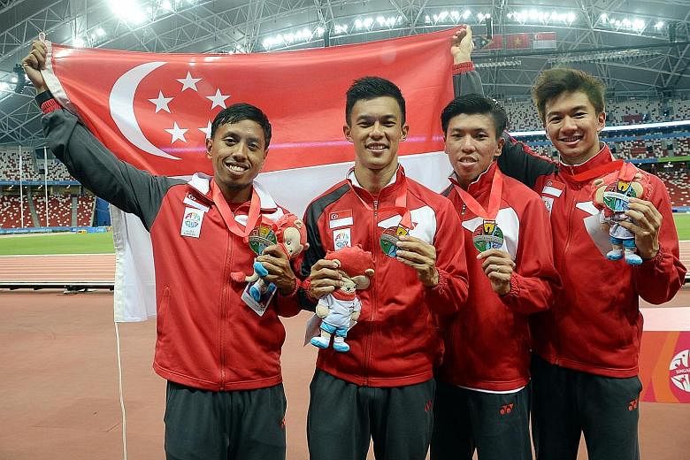 Singapore's 4x100m relay team (from left) Amirudin Jamal, Lee Cheng Wei, Gary Yeo and Calvin Kang after winning silver at the SEA Games last year. Three of them have since retired with only Kang remaining, but he has yet to train with potential new t