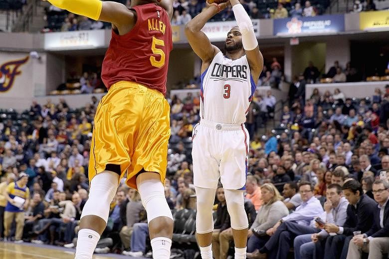 Chris Paul (right) of the Los Angeles Clippers shooting in the game against the Indiana Pacers. The Clippers won 91-89.