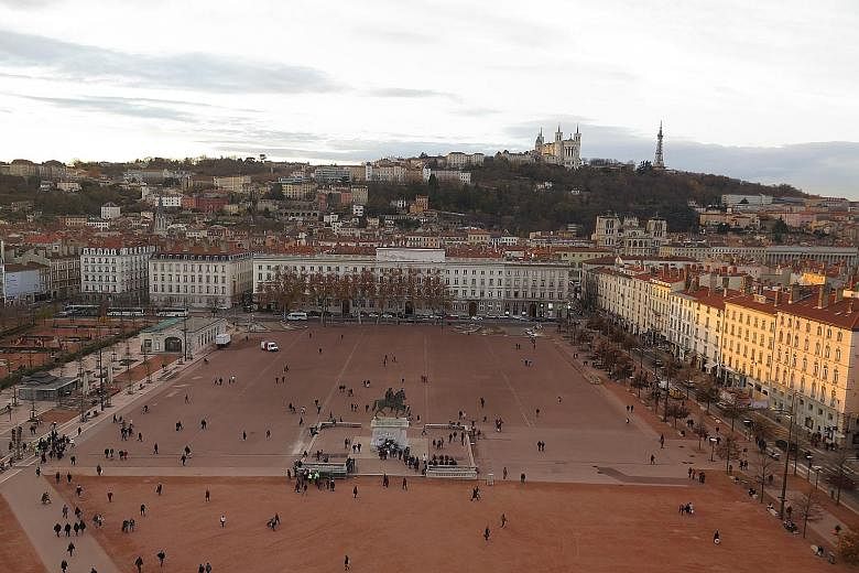 The giant Ferris wheel (far left) looks over the Place Bellecour in Lyon (left). The trip in the Ford S-Max started and ended in Paris.