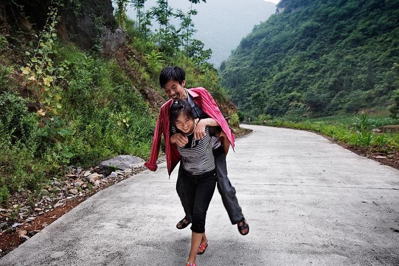 (Top) Former gold miner He Quangui, 41, who is dying of silicosis, with his wife Mi Shixiu, 36, who takes care of his every need and the family. The pair were part of Sim Chi Yin's (above) Dying To Breathe project.