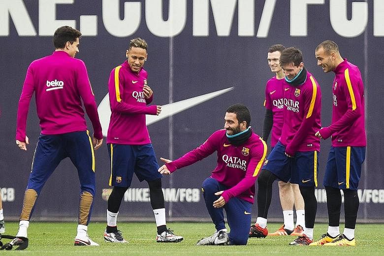 Barcelona's former Atletico Madrid player Arda Turan (centre) joking with team-mates during training yesterday. He will be taking on Atletico for the first time since making the switch following a four-year spell at the Vicente Calderon.