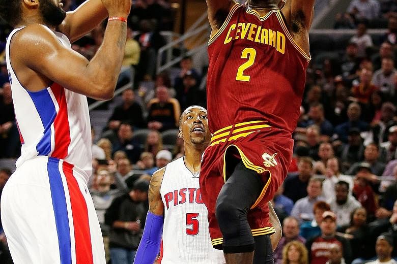 Cleveland's Kyrie Irving (right) getting to the basket past Detroit's Andre Drummond during the second half at The Palace. The Cavaliers beat the Pistons 114-106.