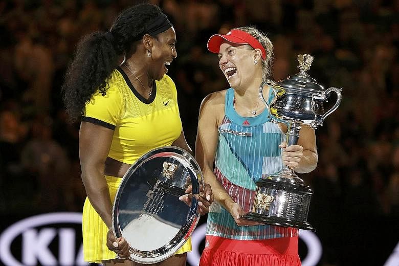 Angelique Kerber sharing a light moment with Serena Williams as she holds the Daphne Akhurst Memorial Cup after winning the three-set final.