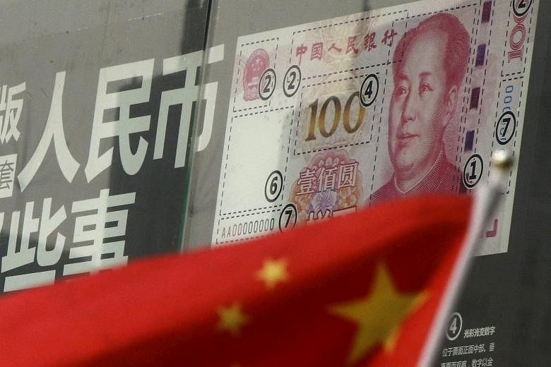A Chinese national flag in front of a poster explaining the design of the new 100-yuan banknote.