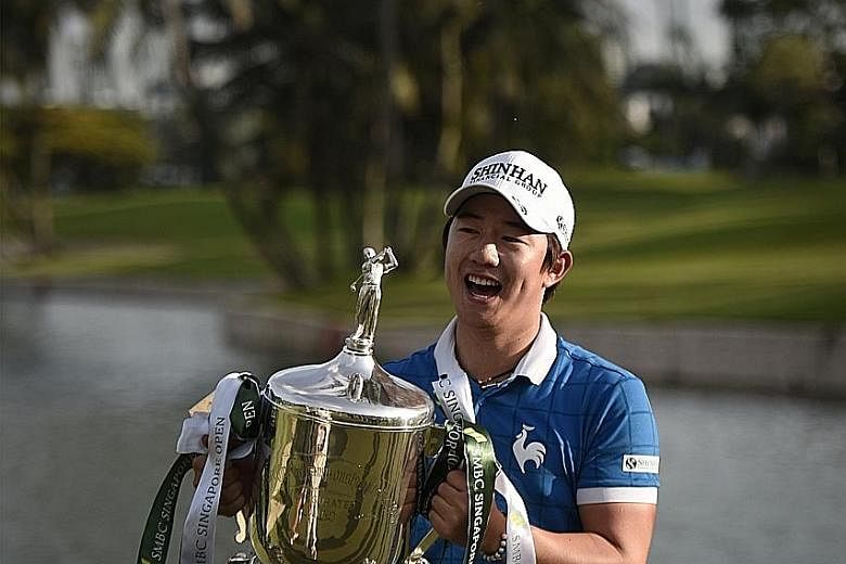 South Korean golfer Song Young Han with the SMBC Singapore Open trophy at the Sentosa Golf Club yesterday, after edging out his role model, world No. 1 Jordan Spieth, by a shot to win the US$1 million (S$1.4 million) tournament. He shot a final round