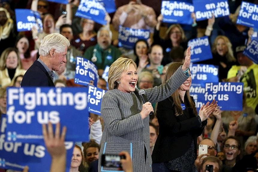 US Democratic presidential candidate Hillary Clinton on stage with her husband, former president Bill Clinton, and daughter Chelsea during a campaign rally at Abraham Lincoln High School in Des Moines, Iowa, on Sunday.