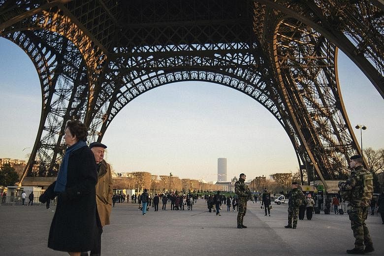 Soldiers on patrol at the Eiffel Tower in Paris last month. France is spending nearly €1 million (S$1.5 million) a day on heightened security across the country, part of a renewed surge in European military spending.