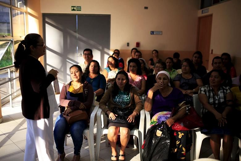 Patients at a Zika prevention talk as they wait to be attended to at the Women's National Hospital in San Salvador, El Salvador, last Friday. Zika is here to stay in the Western Hemisphere; it will be part of life for many years to come, says the writer. 