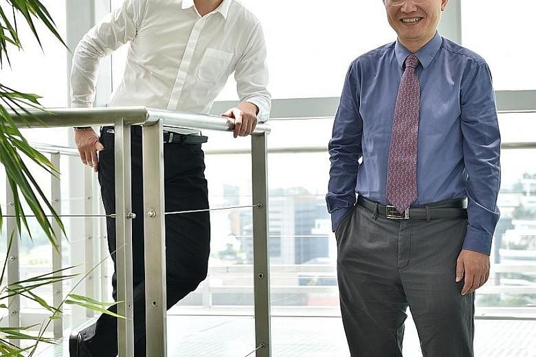 Dr Fang (far left), executive director of InvitroCue, with the firm's scientific mentor and adviser, Prof Yu. Many of the technologies InvitroCue is commercialising were developed by Prof Yu and his team.