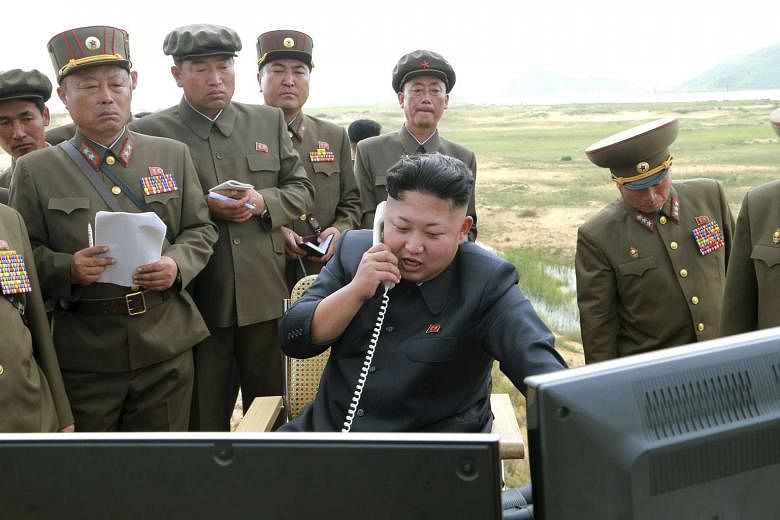 North Korean leader Kim Jung Un guiding the test fire of a tactical rocket in this undated photo released by the Korean Central News Agency on Aug 15, 2014. 