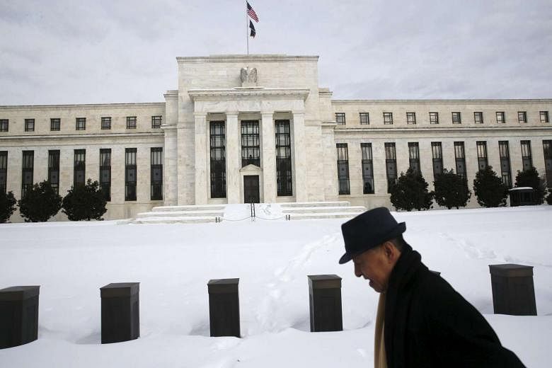  A man walks past the US Federal Reserve in Washington on Jan 26, 2016. 