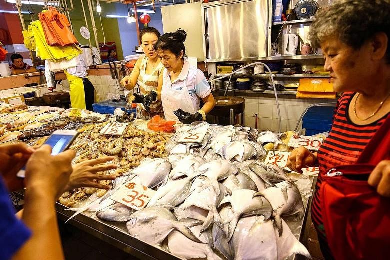 Pomfret is a popular item for reunion dinners. At this market stall in Chinatown, they were $35 each. The silver pomfret - deemed the best-tasting of the breed and favoured for its auspicious name - is much pricier.