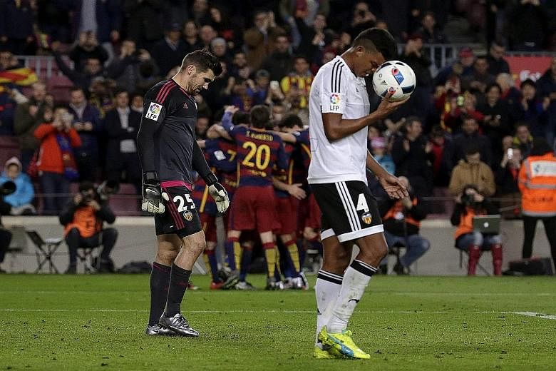 Valencia goalkeeper Matthew Ryan and defender Aderlan Santos down in the dumps after conceding their sixth goal during the King's Cup semi-final first-leg match at the Nou Camp. It ended 7-0 to Barcelona.