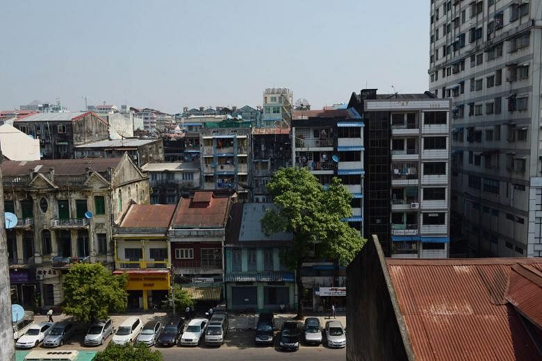 The concrete shell of a colonial-era building stands forlorn in a demolition site, one of a clutch of heritage sites in Yangon (above) to face the wrecking ball in recent months. Myanmar conservation experts fear developers are rushing through controversi