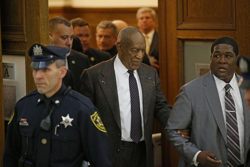 Bill Cosby being led out of the courtroom in Montgomery County Courthouse in Norristown, Pennsylvania, on Wednesday. His lawyers argue that a 2005 deal with a former district attorney means Cosby cannot be prosecuted. 
