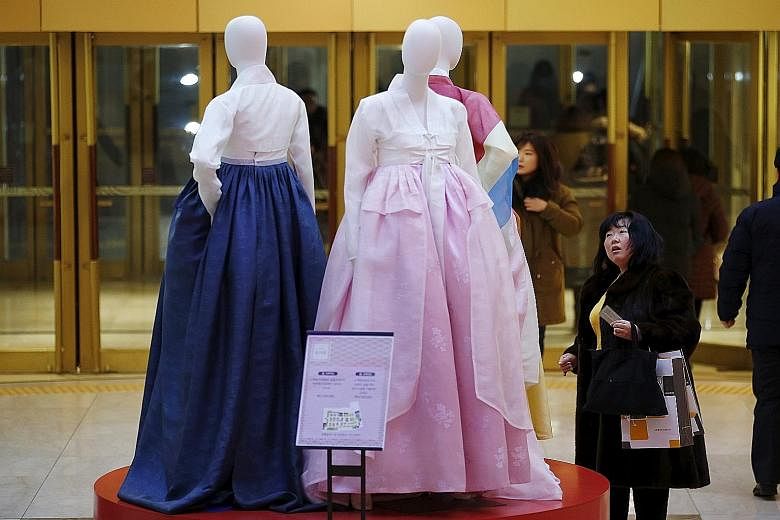 A Chinese tourist at a Seoul department store. Younger Chinese visitors to South Korea are opting to buy cheaper home-grown brands.