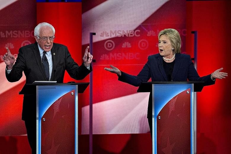 Democratic presidential candidates Bernie Sanders (above, left) and Hillary Clinton speaking at a debate at the University of New Hampshire on Thursday. Mrs Clinton faces an uphill battle in winning over younger voters, who polls show identify strong