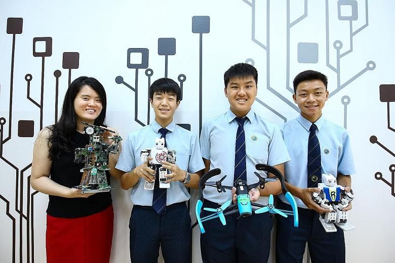 (From left) Ms Chua Shi Qian, head of Hong Kah Secondary's special projects department, and Secondary 3 students Kang Taehyeoh, Ethan Lim and Wilson Lim are hoping the school can get funding so they can teach primary school pupils in the Jurong West 