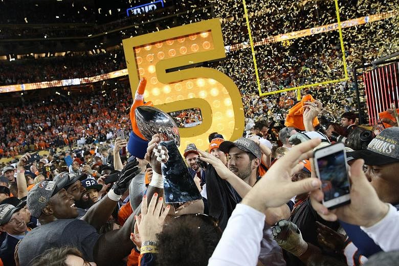 Denver Broncos QB Peyton Manning's son reaches for the Lombardi trophy at Super  Bowl 50 at Levi's Stadium in Santa Clara, California on February 7, 2016.  Denver wins Super Bowl 50 defeating