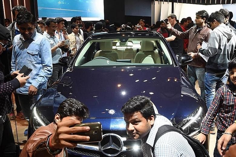 Visitors at the Auto Expo 2016 on the outskirts of New Delhi, India, on Monday. Prime Minister Modi is caught between the urge to boost spending in an economy that is showing mixed signs of strength, and the need to curb expenditure to meet Budget de