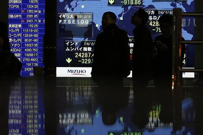 An electronic board showing stock indices outside a brokerage in Tokyo on Tuesday. Japanese corporate leaders, however, are shrugging off the market troubles.