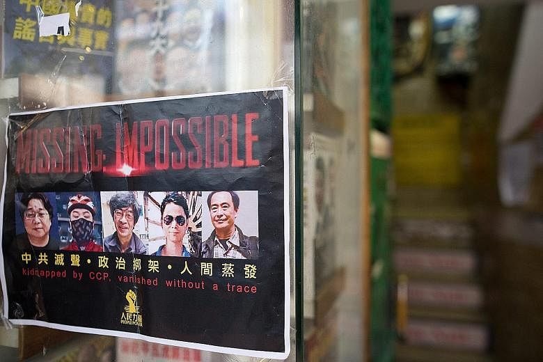 A flier with the photos of five book publishers and editors who went missing, at the entrance to a bookshop in Hong Kong.
