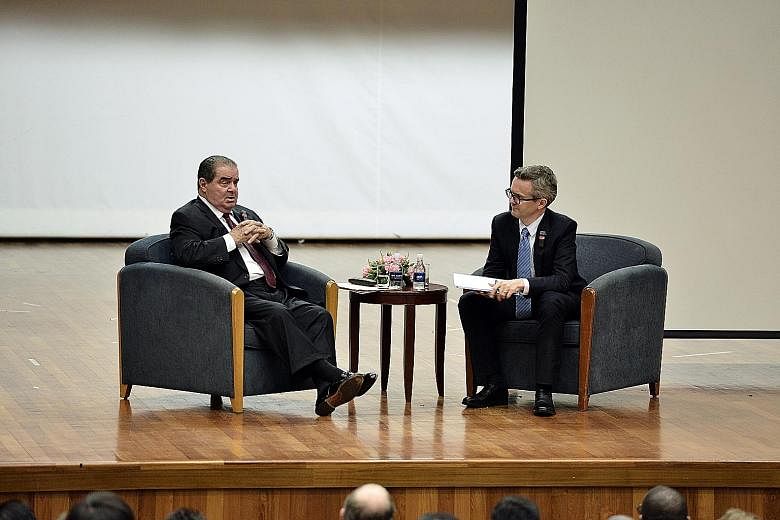 Justice Scalia (left) fielding questions during a dialogue at NUS Law, with Prof Chesterman.