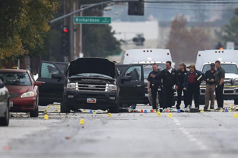 Law enforcement officials conducting their investigation around the vehicle used by Syed Farook and Tashfeen Malik (below) at the scene of the police shootout with the couple last December. The couple gunned down 14 people at an office party before t