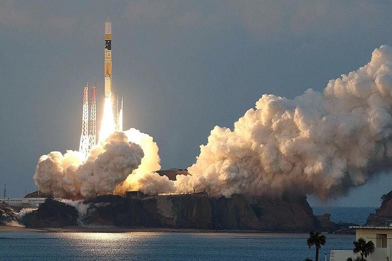 An H-IIA rocket, carrying the ASTRO-H satellite, lifting off at Tanegashima Space Centre yesterday.