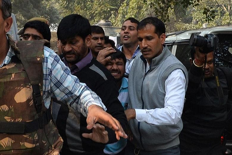 A frightened-looking Kanhaiya Kumar (centre) being escorted by police into the Patiala House Court in New Delhi. He had been arrested for allegedly shouting anti-India slogans at a rally last week to protest against a Kashmiri separatist's execution 