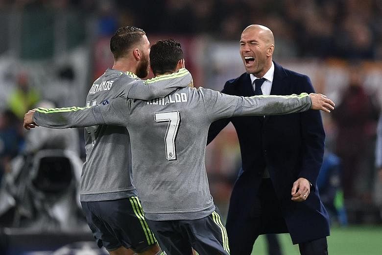 Real Madrid's Cristiano Ronaldo (centre) celebrates his goal with captain Sergio Ramos and manager Zinedine Zidane in their 2-0 win over AS Roma. The Portuguese is currently the top scorer of this season's Champions League, with 12 goals to his name.