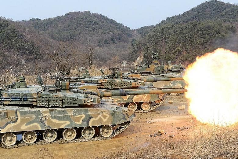 South Korean army tanks during a live firing drill yesterday. The United States and South Korea will be holding two joint military exercises next month.