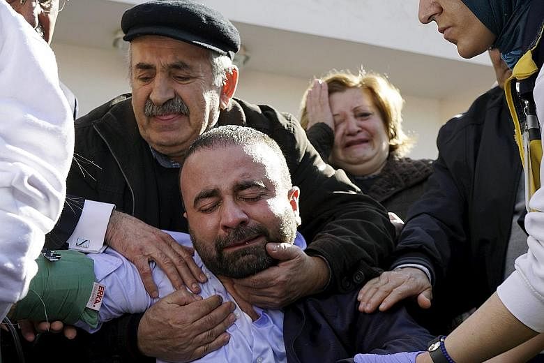Grief-stricken family members of some of the car bombing victims outside a morgue in Ankara yesterday.