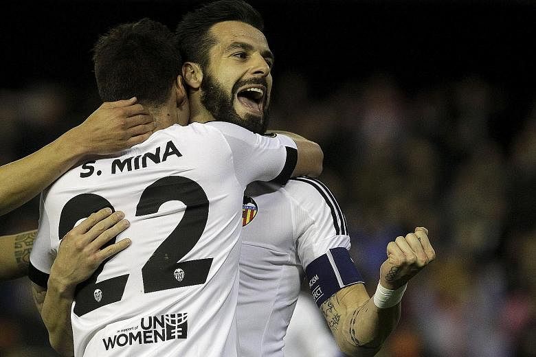 The clenched fist of Valencia's Alvaro Negredo speaks volumes as he embraces team-mate Santi Mina during the 6-0 rout of Rapid Vienna in their Europa League clash. The win further eased the pressure on Gary Neville, who turned 41 that day.