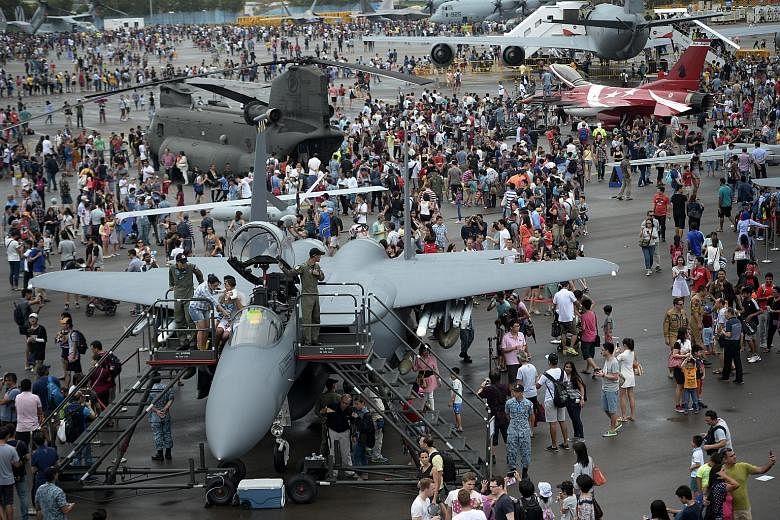 A queue (left) forms as visitors wait for a chance to sit in the cockpit of an F-15SG from the Republic of Singapore Air Force, probably the closest they will ever get to such a fierce fighter. It is not all strictly a display of macho military might