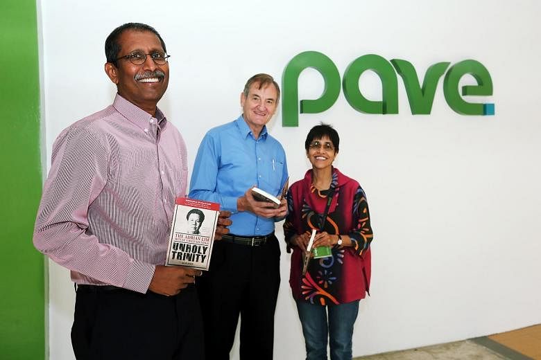 Vice-president of Pave Alan John, president Michael Gray and executive director Sudha Nair, with copies of the newly launched reprint of Mr John's book, Unholy Trinity. Mr John is donating royalties from the book's sales to the charity.