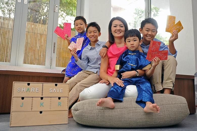 Ms Priscilla Ang with her children (from left) Kate, eight, Joshua, 10, Zachary, five, and Ryan, 12. The director at a technology company puts the children's' hongbao money into endowment funds for university expenses. Each child collects about $1,20