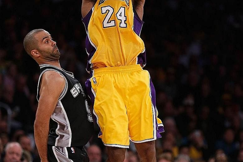 Los Angeles' Kobe Bryant taking a shot past San Antonio's Tony Parker during the second half at Staples Centre on Friday. The Spurs defeated the Lakers 119-113.