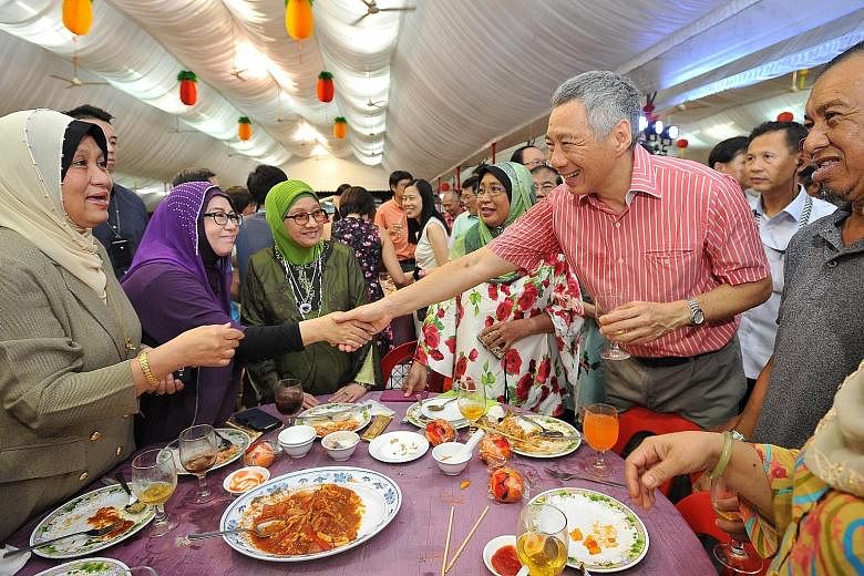 PM Lee Hsien Loong meeting actress Aznah Hamid, 57, at the table with Teck Ghee's Pioneer Generation residents during the Chinese New Year celebration dinner last night.